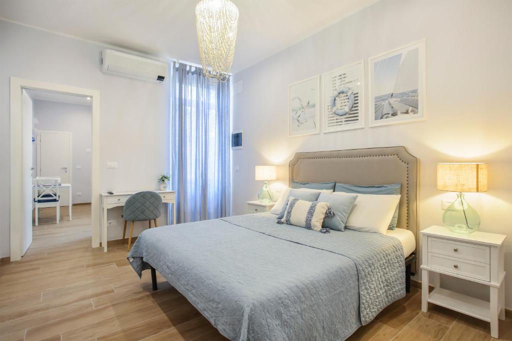 a bedroom with a bed and a desk and a table at VERSILIA MIA - beach at 8min by walk - new rooms! in Viareggio