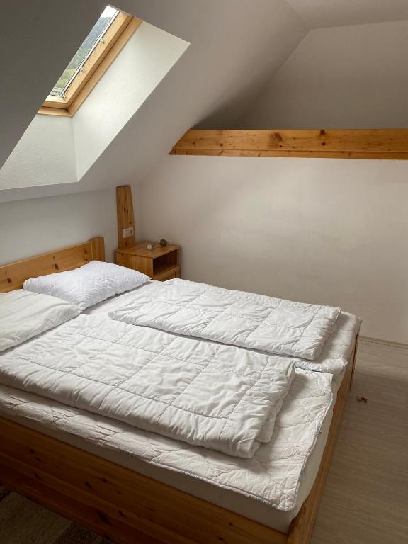 A bed or beds in a room at Waldschlössl Gasthof