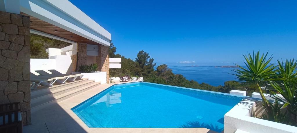 a swimming pool in a villa with a view of the ocean at Ibiza 7th Heaven Villa in Sant Josep