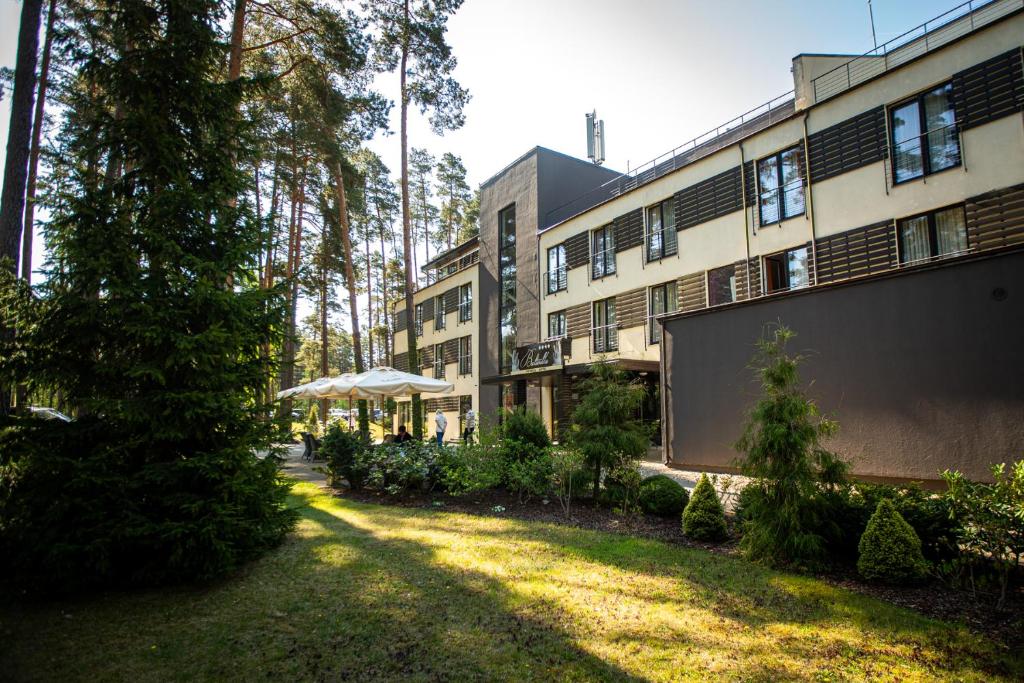 a building with a yard in front of it at Baltvilla in Baltezers