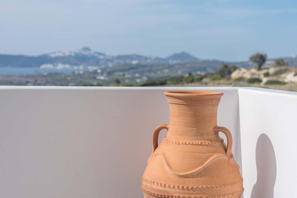 a vase sitting on top of a white wall at Sunset Village 6 in Paleochori