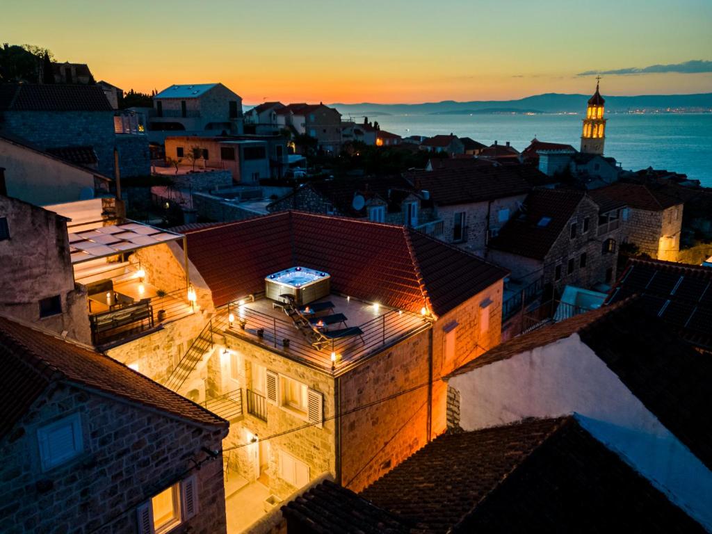 Una vista de una ciudad de noche con un faro. en Villa Nora - Charme Holidays, en Sutivan