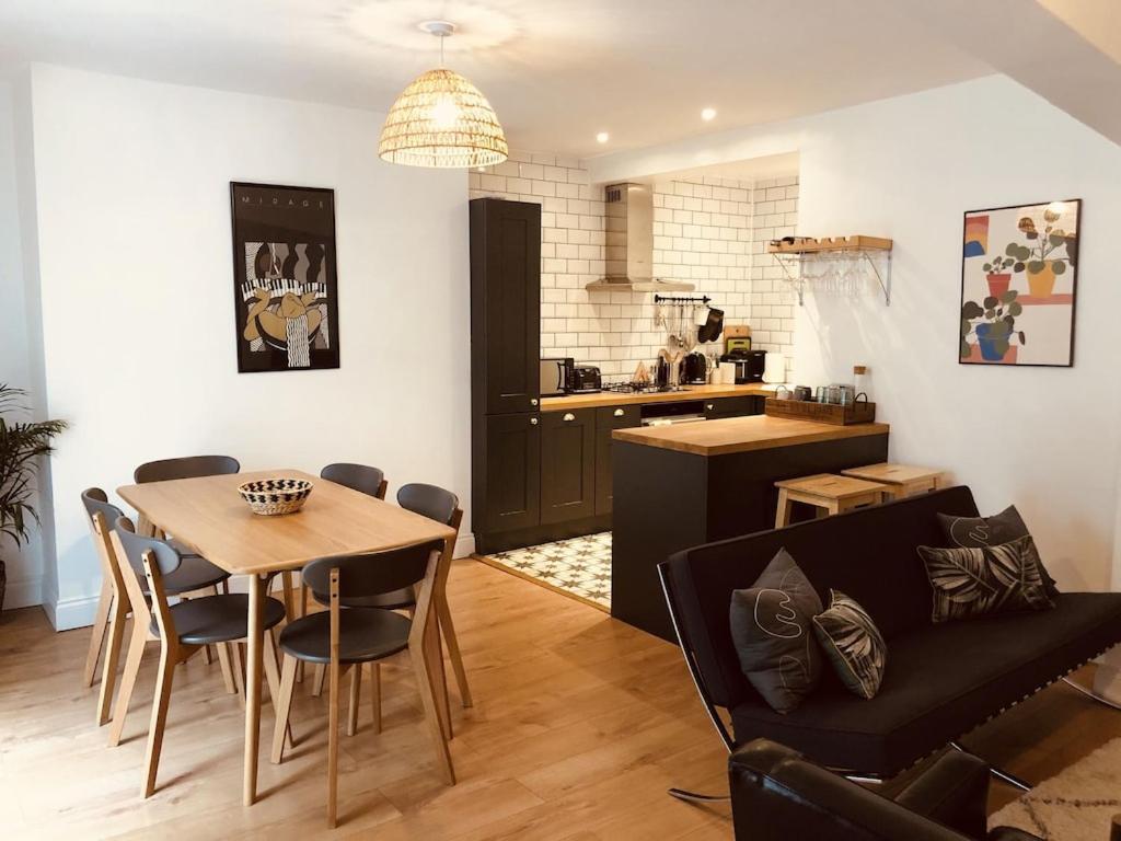 ein Wohnzimmer und eine Küche mit einem Tisch und einem Sofa in der Unterkunft Central Brighton flat, 3 bedrooms, sleeps 6, close to shops and beach in Brighton & Hove