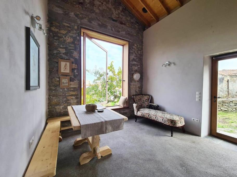 a living room with a table and a chair at Hidden gem of 1900, 7km from sea in Potamós
