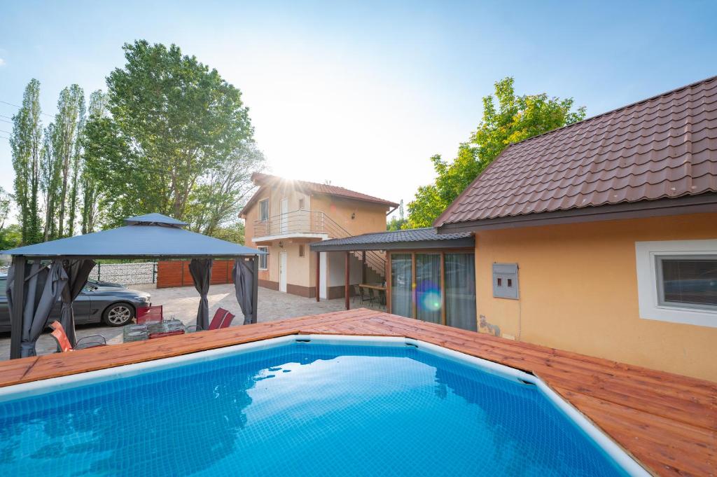 a swimming pool in front of a house at Villa Bezho Ljubanista in Ljubaništa