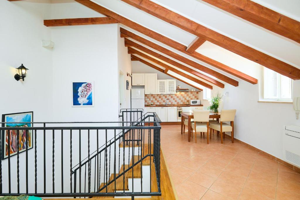 a kitchen and dining room with wooden beams at Apartment Ermineous A34 in Dubrovnik