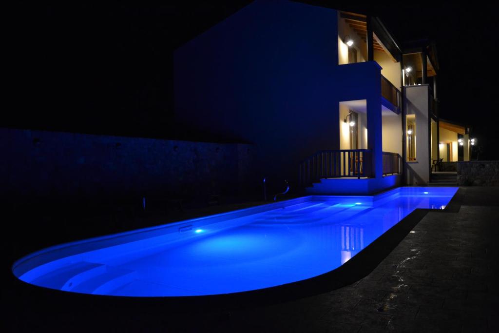 a swimming pool at night with blue lighting at Agriturismo Gradec in Aurisina