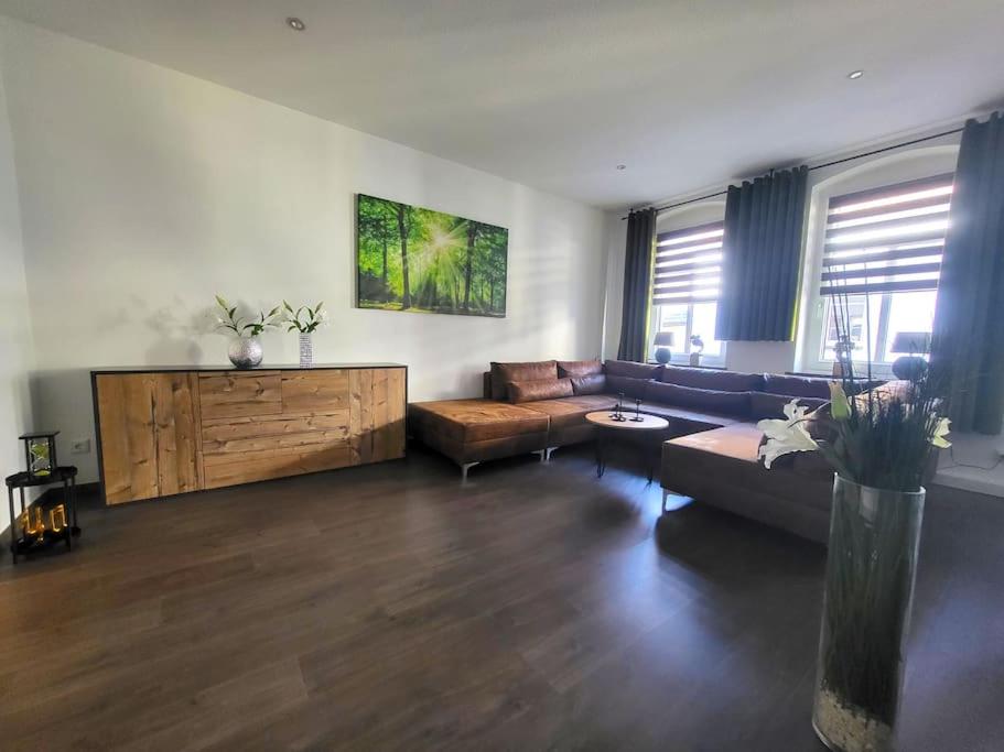 a living room with a couch and a table at Ferienwohnung SehrGemütlich in Lichtenstein-Callnberg