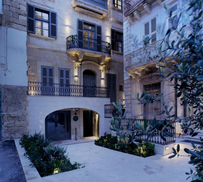 a large building with an archway in front of it at Trabuxu Boutique Living in Valletta