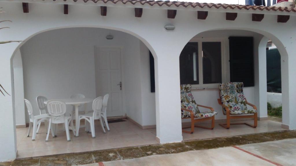 a patio with a table and chairs on it at Grupoandria Villa Dora in Cala en Blanes