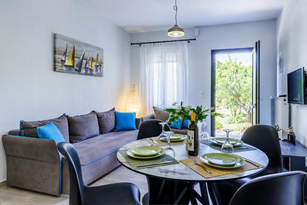 a living room with a table and a couch at The Green Yard Apartment in Skopelos Town