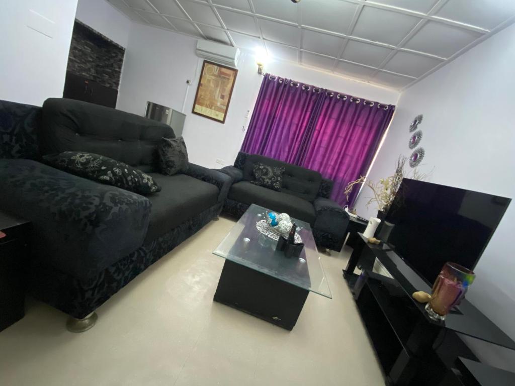 - un salon avec un canapé et une table dans l'établissement Harmonious haven services, à Ibadan