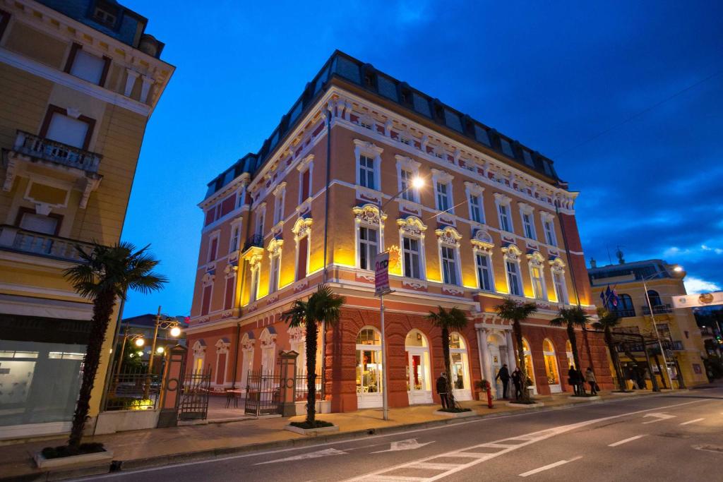 a large building on a city street at night at Hotel Continental ex Gardenija in Opatija