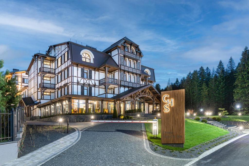 a large building with a sign in front of it at Crona SPA Karpaty in Skhidnitsa