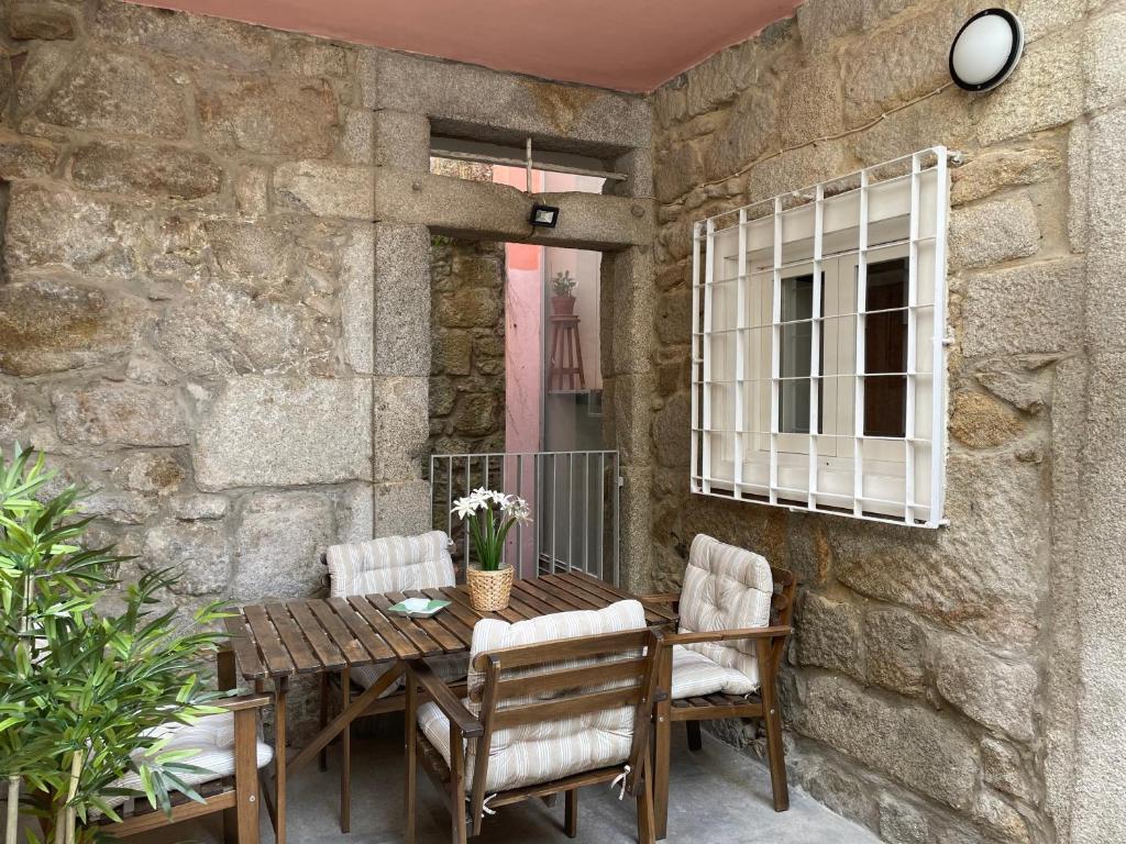 a patio with a wooden table and chairs at Douro River Cozy Apartments in Porto
