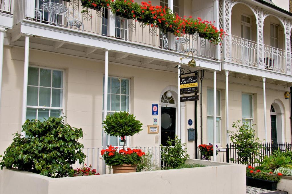 a white building with flowers on the balconies at Pier View Self Catering Luxury Apartments in Southend-on-Sea