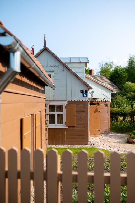 a house with a fence in front of it at i’dille Brīvdienu māja in Kuldīga