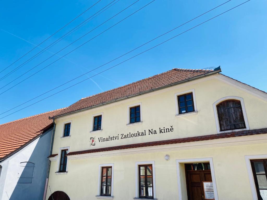 a building with a sign on the side of it at Vinařství Zatloukal Na kině in Pavlov