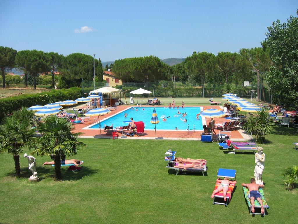 a large swimming pool with a lot of people in it at Camping Badiaccia Village in Castiglione del Lago