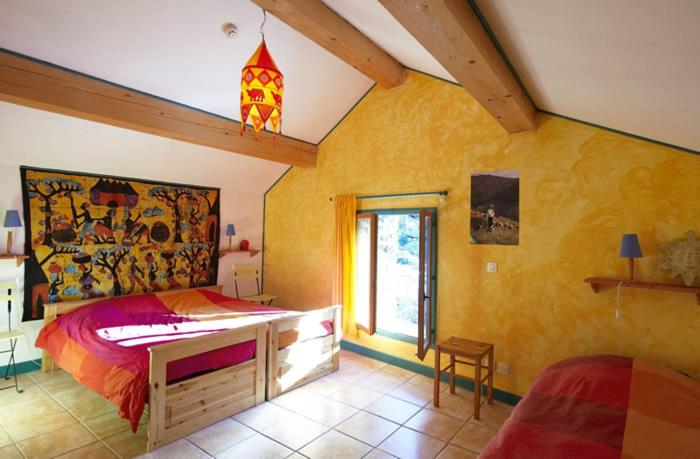 a bedroom with a large bed and a window at Le Mas Franc in Enveitg