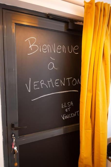 a chalkboard with the words beware a verrification behind a curtain at MAISON DIVISÉE EN 2 APPARTEMENTS POUR 8 PERSONNES in Vermenton