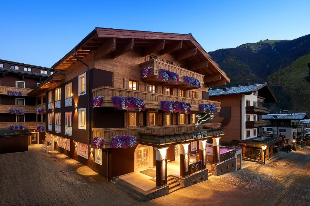 a building with flowers on the front of it at Hotel Panther'A in Saalbach-Hinterglemm