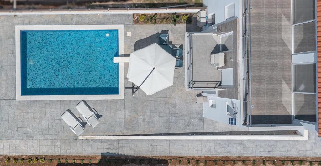 an overhead view of a swimming pool next to a building at Modern, Cheerful & Dream Catching Villa in Corinth in Isthmia