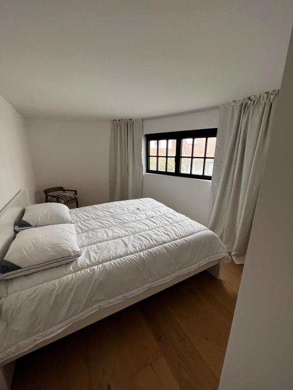 מיטה או מיטות בחדר ב-Duinenhuisje