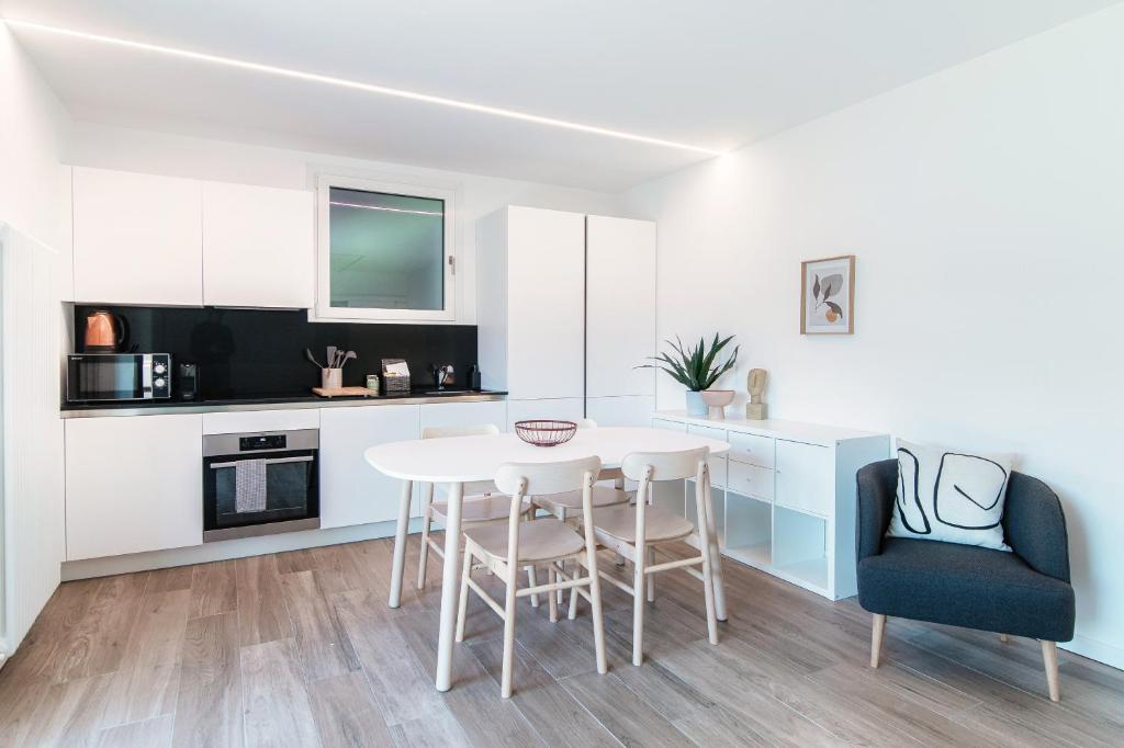 a kitchen and dining room with a table and chairs at La Palma 3 by Quokka 360 - Lake View Studio with Private Terrace in Montagnola