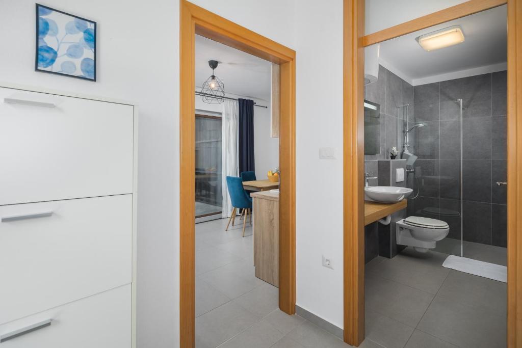 a bathroom with a toilet and a sink at Apartments Špadići in Poreč