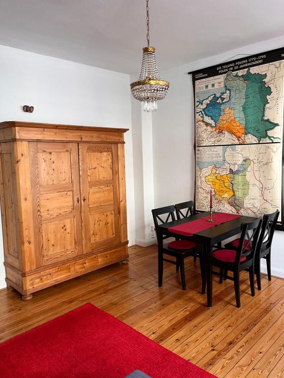 a dining room with a table and a map on the wall at Nord Apartament 3 in Kiel