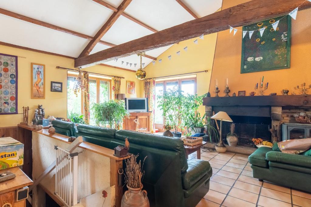 a living room with a couch and a fireplace at La Ferme De Leychoisier in Bonnac-la-Côte