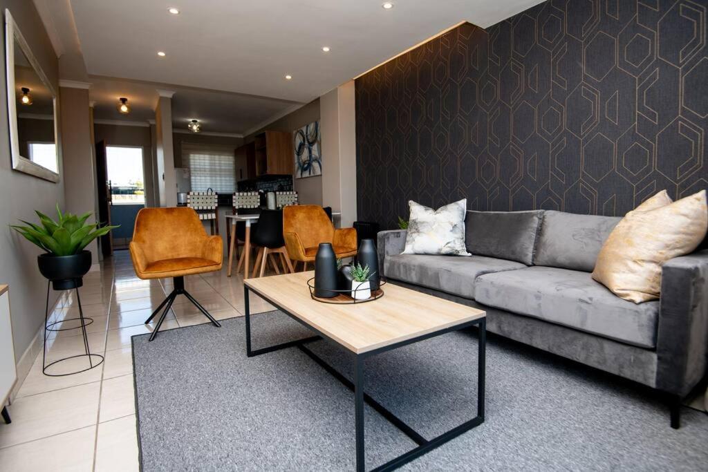 a living room with a couch and a table at Unit 416 at Menlyn Place in Pretoria