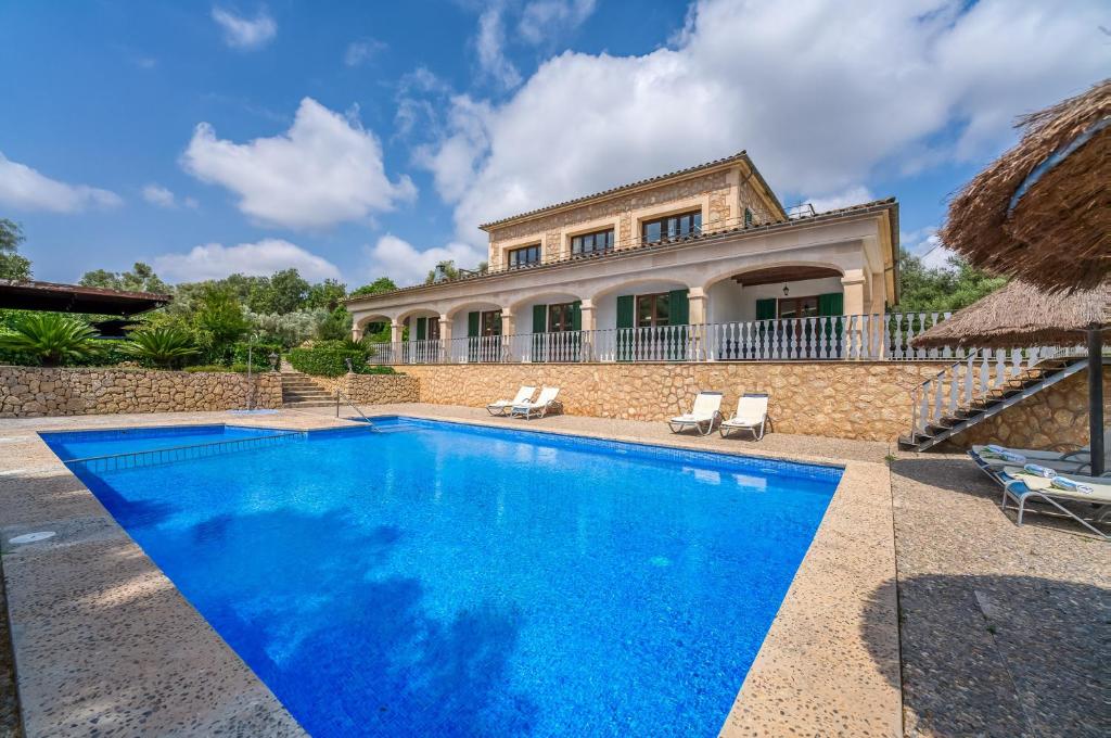 a villa with a swimming pool in front of a house at Ideal Property Mallorca - Sa Pleta in Petra