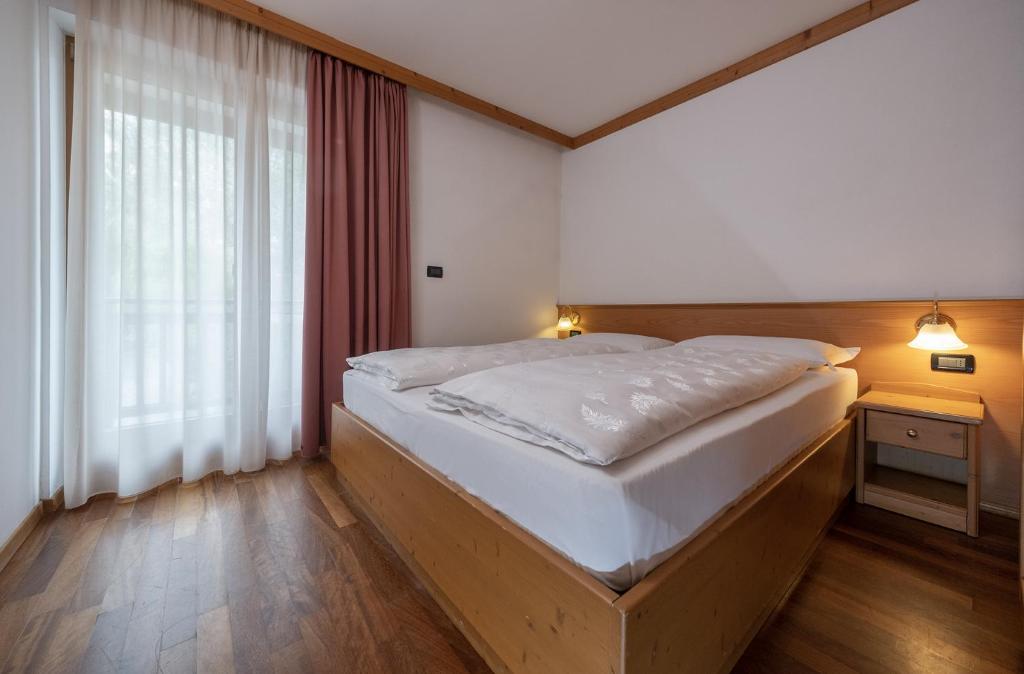 Postel nebo postele na pokoji v ubytování Residence Kristall- Fiemme Holidays