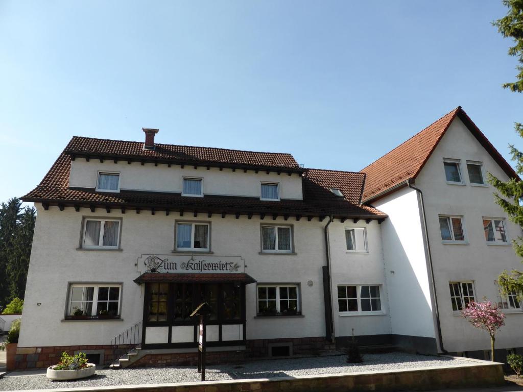 a large white building with a red roof at Zum Kaiserwirt in Heppenheim an der Bergstrasse