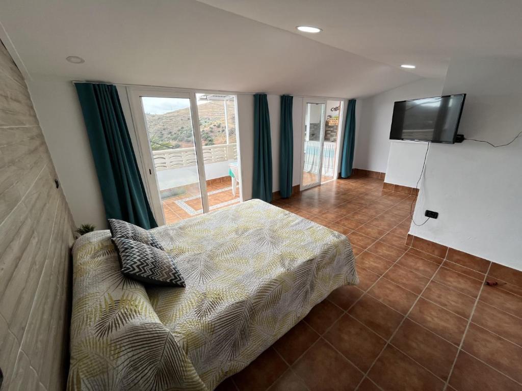 a bedroom with a bed and a flat screen tv at Mirador San Roque in Las Palmas de Gran Canaria