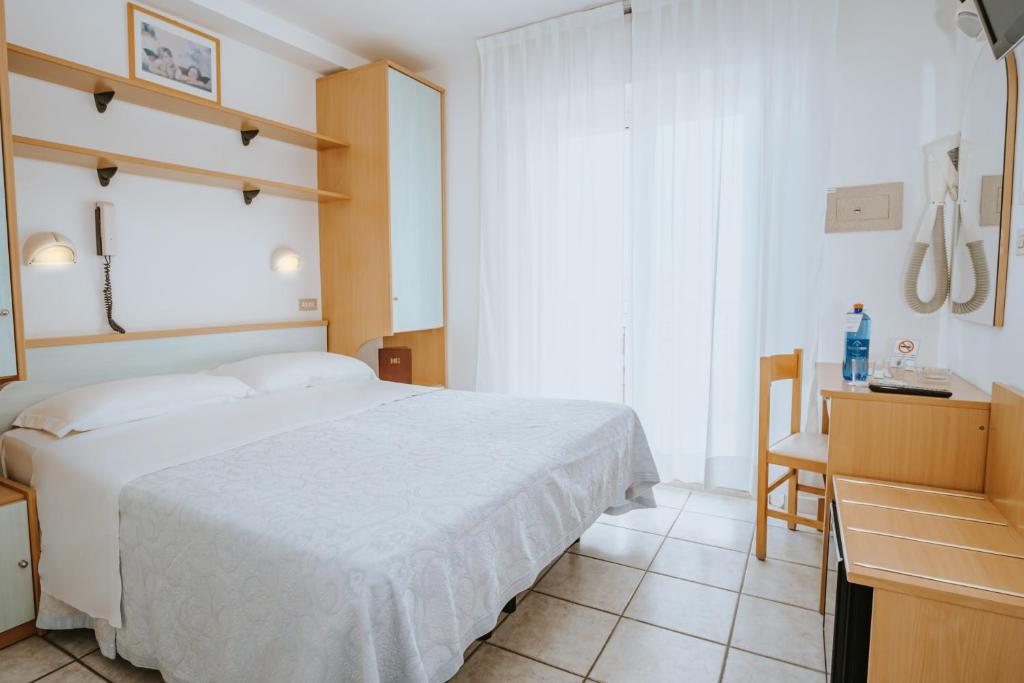 Postel nebo postele na pokoji v ubytování Hotel Gabriella
