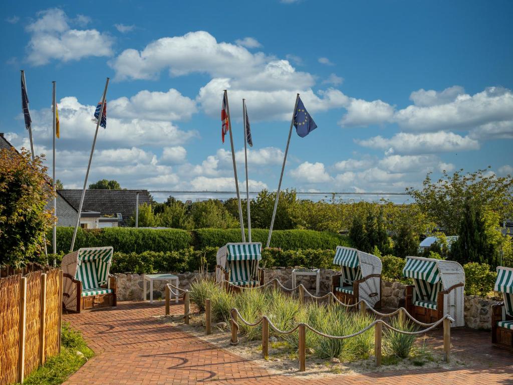 a group of chairs and flags on a patio at Tom's Hus Heiligenhafen in Heiligenhafen