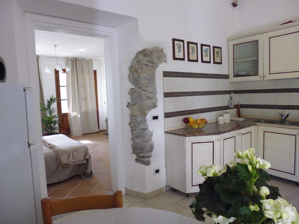 a kitchen with a stone wall in a room at Villa il Poderino in Marina di Campo