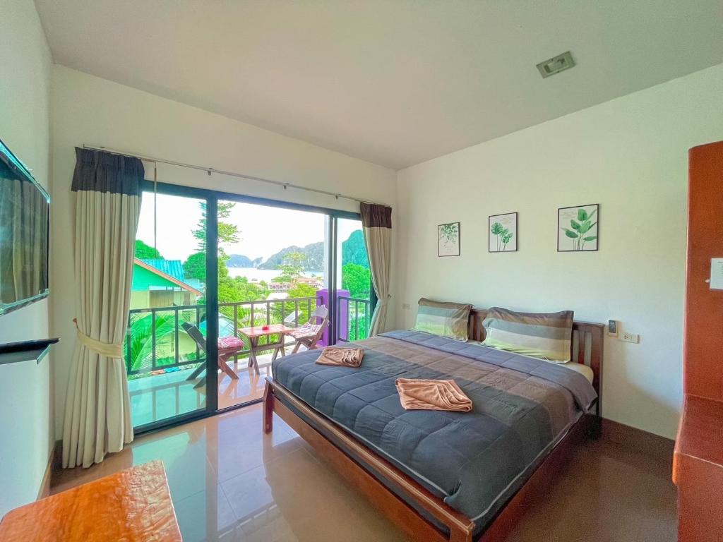 a bedroom with a bed and a balcony at View Garden Resort in Phi Phi Don