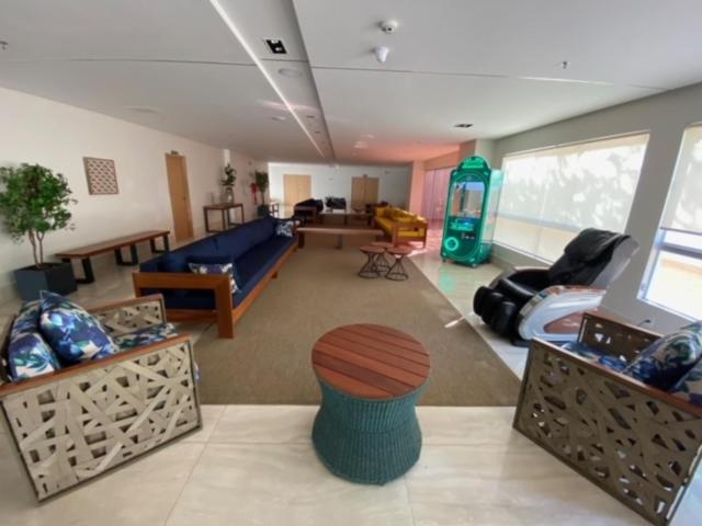a living room with a couch and a living room with at Park Veredas Flat Service in Rio Quente