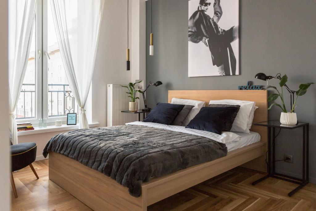 a bedroom with a large bed with blue pillows at Old Town Heart X Luxury - Piekna in Warsaw