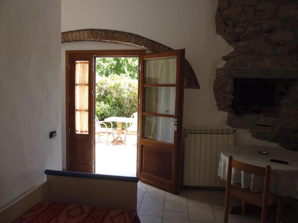 an open door to a patio with a table at Villa il Poderino in Marina di Campo