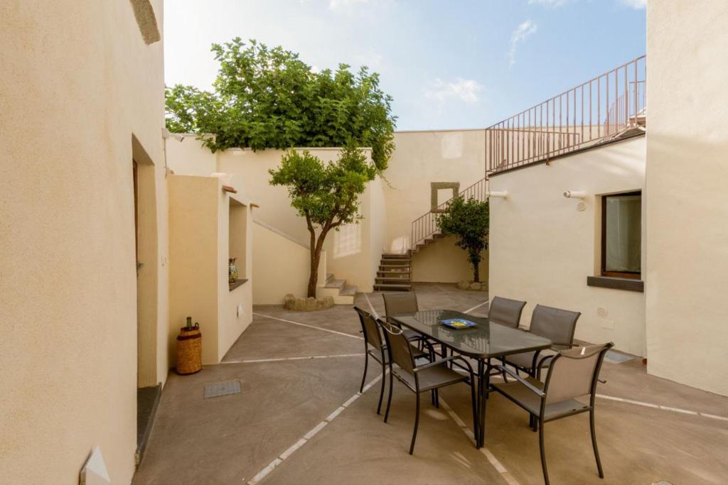 a patio with a table and chairs in a courtyard at Casa Mimina in Ischia