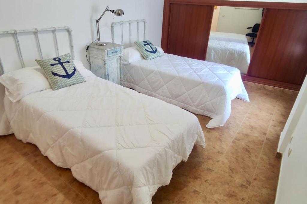 Łóżko lub łóżka w pokoju w obiekcie Apartamento Porto do Xufre