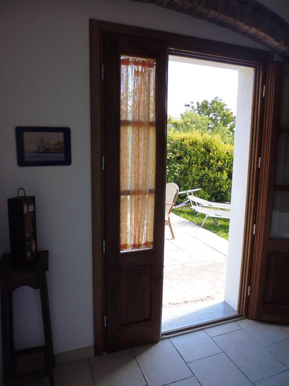an open door to a patio with a sliding glass door at Villa il Poderino in Marina di Campo
