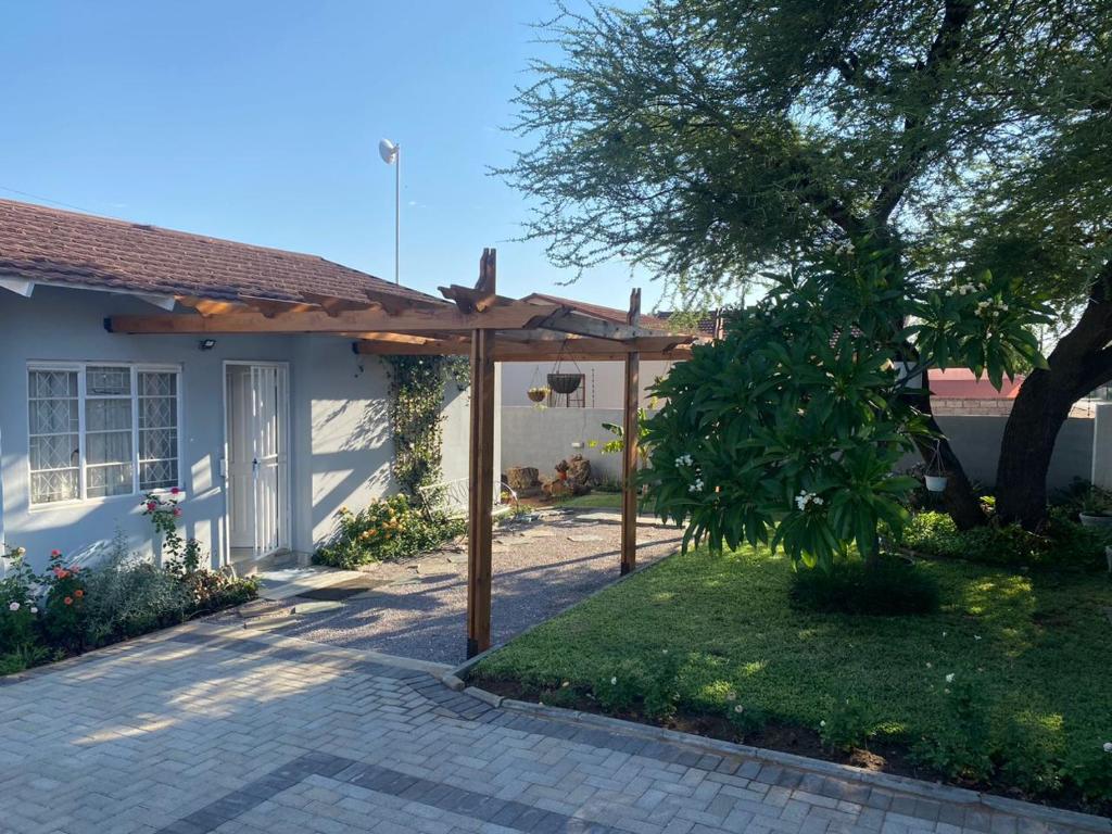 a backyard with a pergola and a house at @20401 in Gaborone