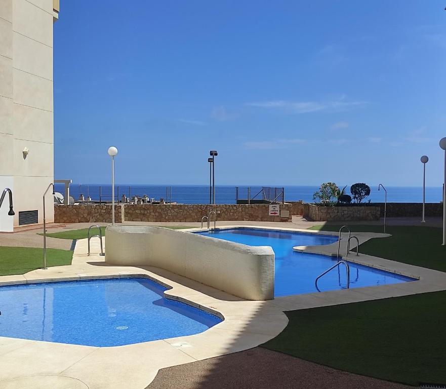 a large swimming pool in front of a building at Dream Sea Golf & Beach in Benalmádena