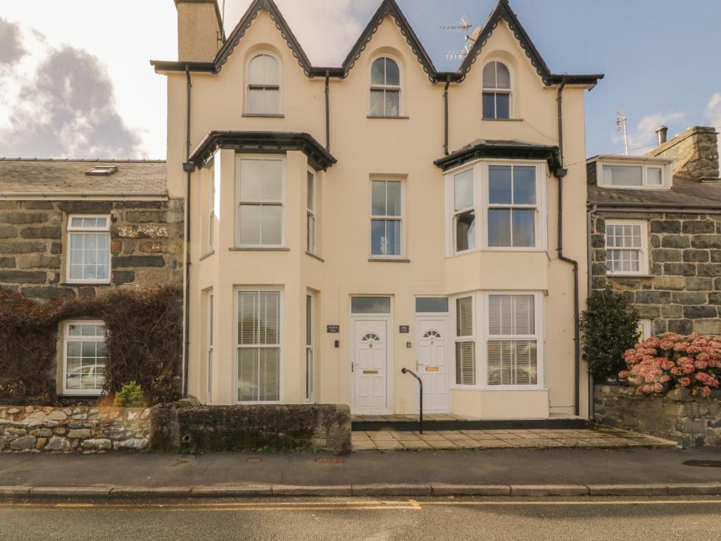 a large white house on the side of a street at Harlech View in Criccieth